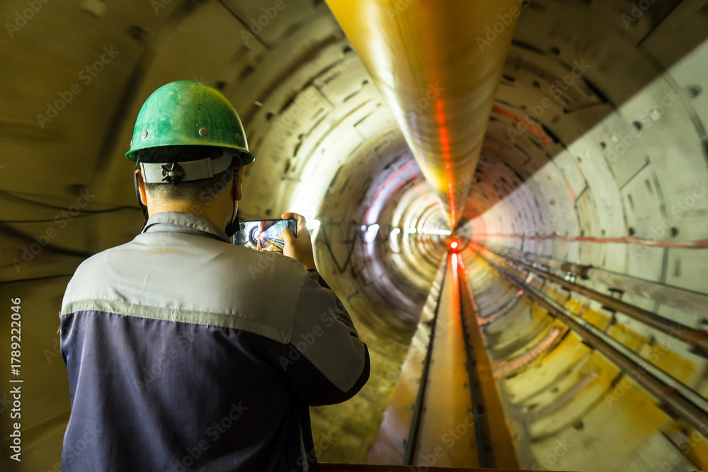 Fototapeta premium Soft focus and blurred lighting background of engineer or technician control to take a photo. Underground tunnel infrastructure. Transport pipeline by Tunnel Boring Machine for electric train subway