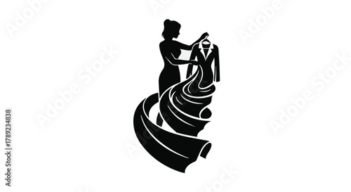 Silhouette of a fashion designer draping fabric over a mannequin creating a stylish garment.
