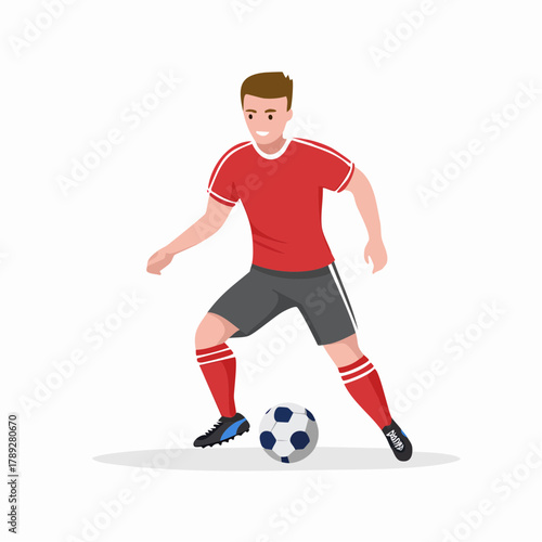 A male soccer player in a red uniform dribbling a football on a white background, actively engaged in the sport.