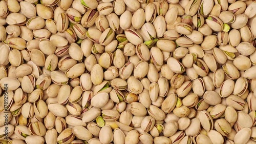 Salted roasted pistachio nuts moving background