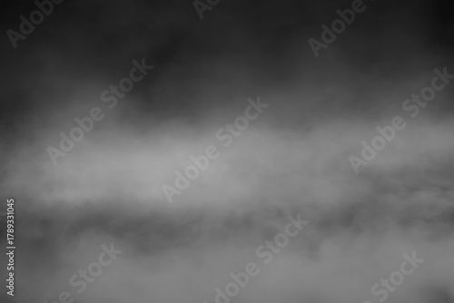 Photos Thick White Smoke and Fog Flowing Horizontally on a Dark Black Background, Abstr