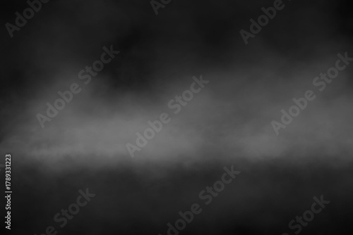 Abstract black background with textured grey fog, smoky mist, or steam effect, creating a mysterious and atmospheric visual for overlays, backdrops, and graphic design projects