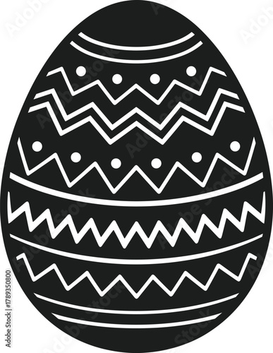 Black Easter egg with white zigzag and dot patterns on white