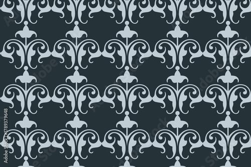 Elegant damask pattern with golden floral ornaments on a dark gray background, creating a vintage and luxurious feel
