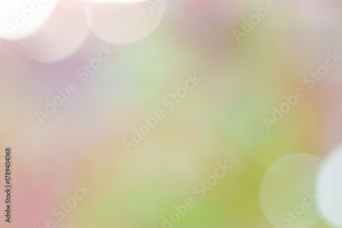 Defocused abstract bokeh background pastel colored, flare from lights, light color gradient, blurred round bokeh as holiday texture. Glittering aesthetic textured lighting pattern, summer mood