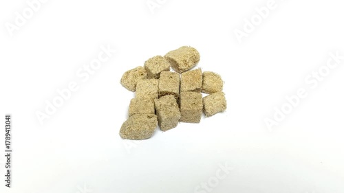 Frozen tubifex worms on a white background. These worms are used as valuable natural fish food due to their high protein content.