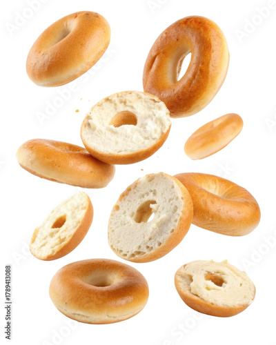 Appetizing fresh baked bagel with cream cheese flying on transparency background. delicious pastry for healthy breakfast, tasty snack food