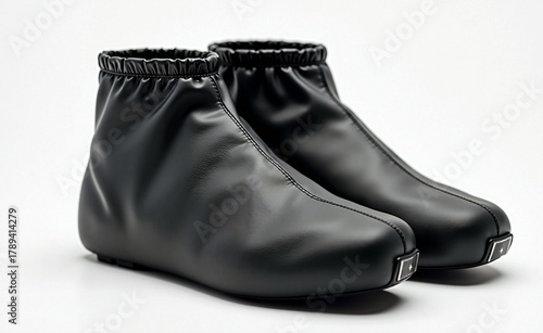 Pair of modern black waterproof shoe covers with elastic tops and matte finish, designed for cycling or rain protection.