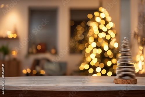 Empty wooden tabletop displaying a modern decorative Christmas tree with blurred festive lights and holiday bokeh in the background