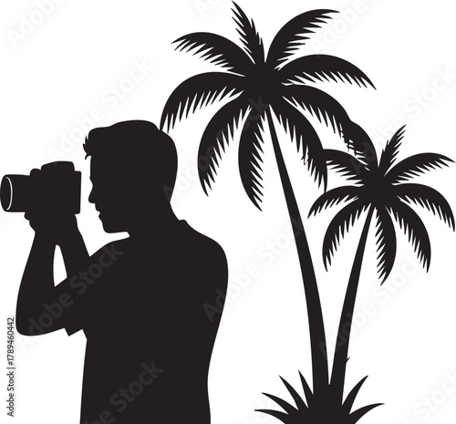 Silhouette of a photographer captures images of tropical palm trees on a clear day