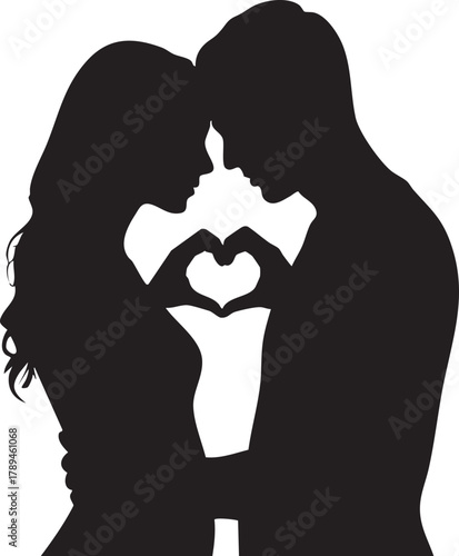 Silhouette shows a couple embracing and making a heart shape with their hands