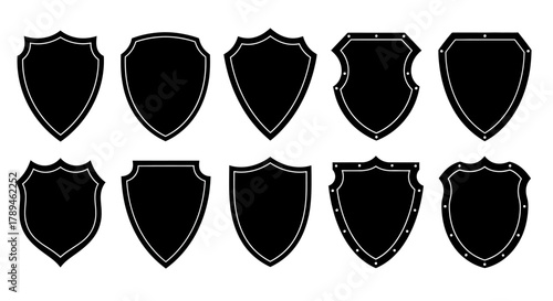 Collection of ten black heraldic shield shapes with distressed texture isolated on white background