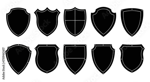Collection of ten different black shield silhouettes on a white background representing heraldry and security
