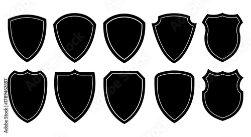 Collection of ten diverse black shield shapes and outlines on a white background for design elements