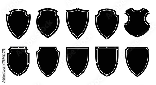 Collection of ten black shield silhouettes with distressed edges on a white background