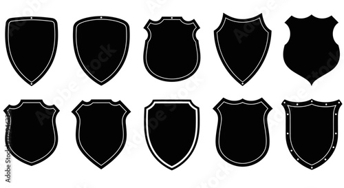 Collection of ten different black shield silhouettes on a white background representing security and protection