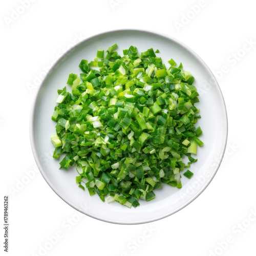 Chopped green onions on white plate, top view, isolated on black