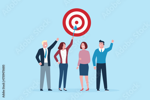 Diverse team celebrating hitting their business target with an arrow in the bullseye of a dartboard
