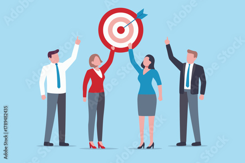 Diverse business team celebrating achieving their common goal with an arrow hitting the bullseye on a target
