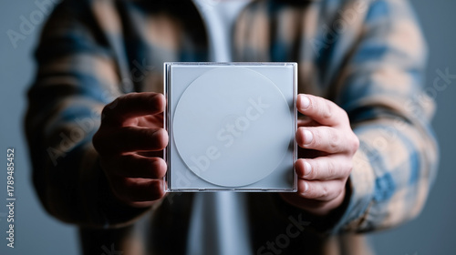 A person is holding a CD case