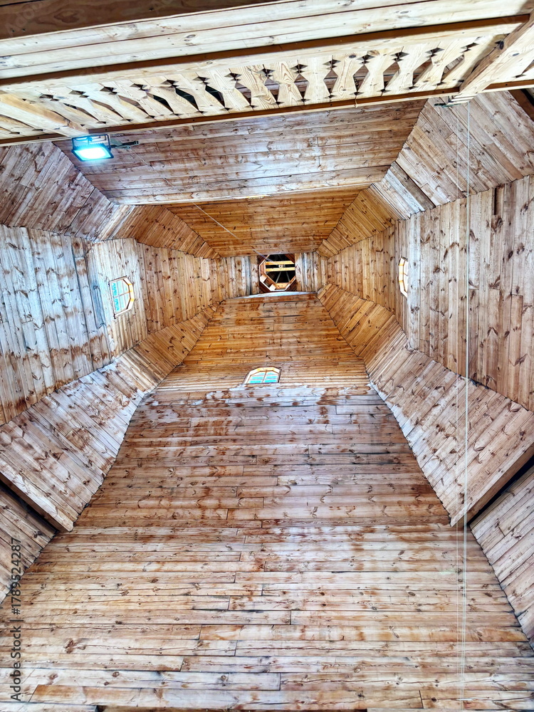 Obraz premium A view up to the bell tower of the ancient wooden church of the Cossacks of the Zaporizhian army in the Sich.