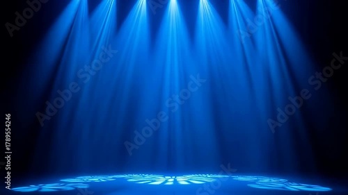 Stage Lighting Showcasing Blue Beams of Light on a Dark Background with Hexagonal Patterns on the Floor