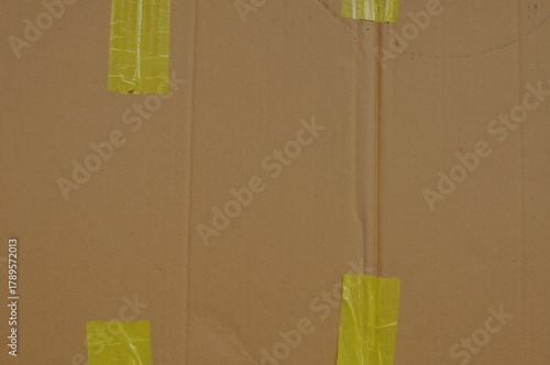 corrugated cardboard box surface texture with yellow stricker