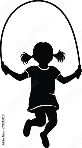 Black silhouette of a young girl with pigtails jumping rope in mid-air child skipping