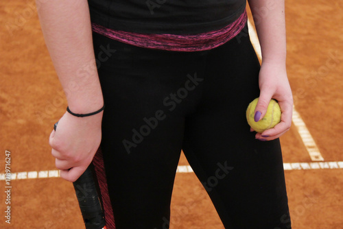 Female Tennis Player Ready to Serve – Focus and Determination on Clay Court