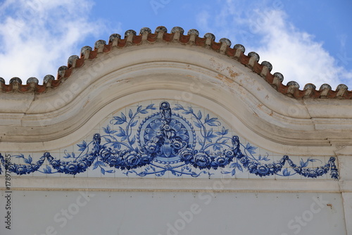 Historic facade with traditional blue ceramic tiles in the old town of Loule, Algarve, Portugal  
