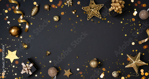 Christmas decoration objects on black background top view with holiday ornament and copy space in center