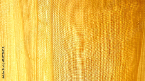 Warm, Luxurious Close-up of Natural Golden Beige Linen Fabric with Soft Vertical Folds and Subtle Wrinkles, Perfect Minimalist Textile Background for Design and Advertising