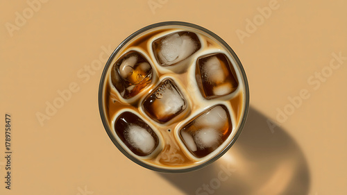 Refreshing iced coffee with milk and ice cubes, top down view
