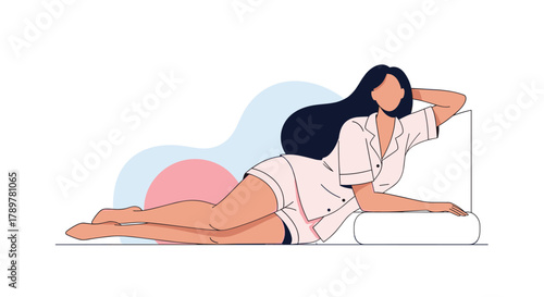 A young woman in comfortable pink pajamas poses while lying on her side, resting her head on an arm, with a calm background.