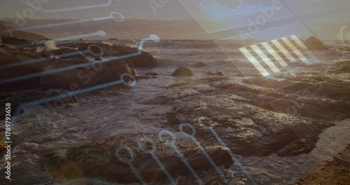 Breaking waves flowing across wet boulders, tide pools at low tide, showing circuit overlay © vectorfusionart