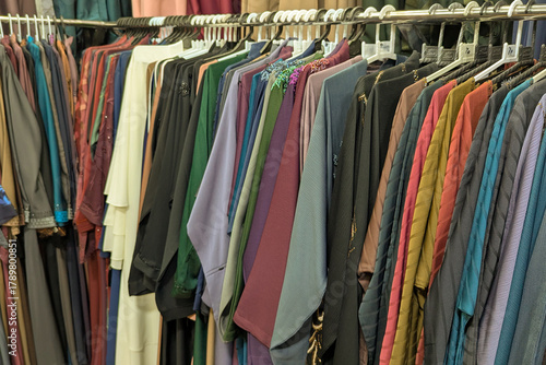 Mix colors Traditional Arabic abayas and clothing are displayed for sale at a cloth store in Souq Waqif, featuring intricate designs and cultural elegance.