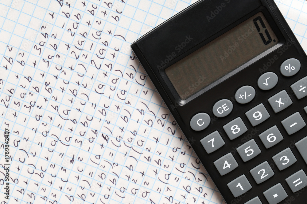 Obraz premium Copybook with handwritten maths formulas and calculator as background, closeup