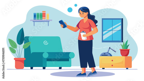 A woman is standing in a living room with a remote in her hand. She is looking at her phone
