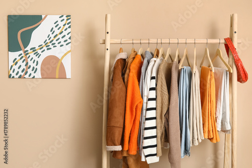 Rack with clothes near beig...