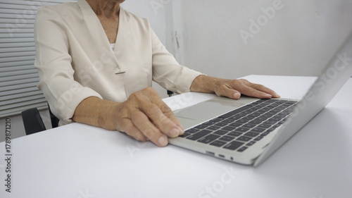 businessman hands searching for data on Notebook with analyzing charts at his workplace.