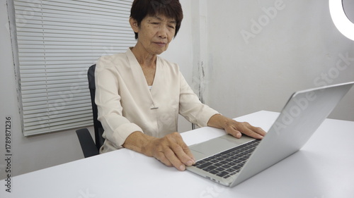 businessman hands searching for data on Notebook with analyzing charts at his workplace.