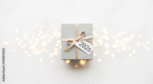 A small gold ring gift box for 2026 with a red ribbon bow on white background for valentine wedding or anniversary celebration