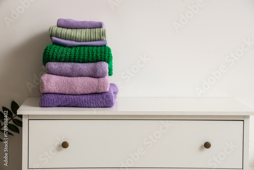 Folded winter sweaters on c...