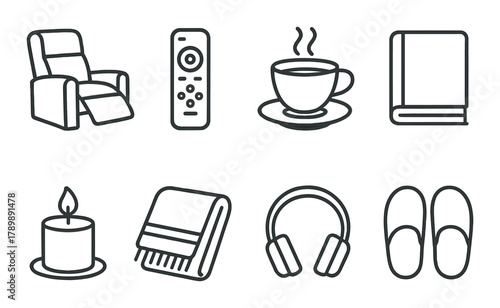 Cozy lounge essentials: recliner, remote, coffee, book, candle, blanket, headphones, slippers