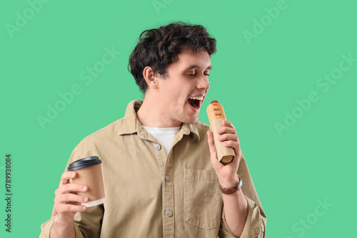 Young man with tasty hot do...