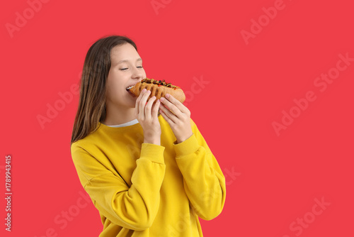 Young woman eating tasty ho...