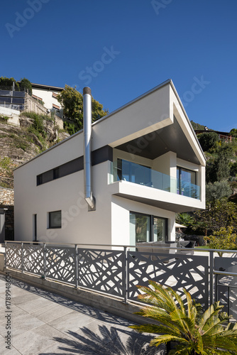 Detail of a modern white single-family house with terrace. .