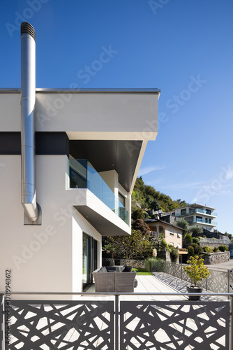 Detail of a modern white single-family house with terrace.
