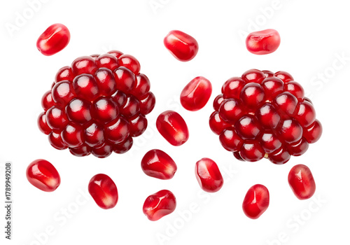 Fresh ripe pomegranate arils on a clean background, vibrant red fruit seeds isolated.