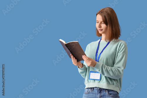 Young woman reading book on...